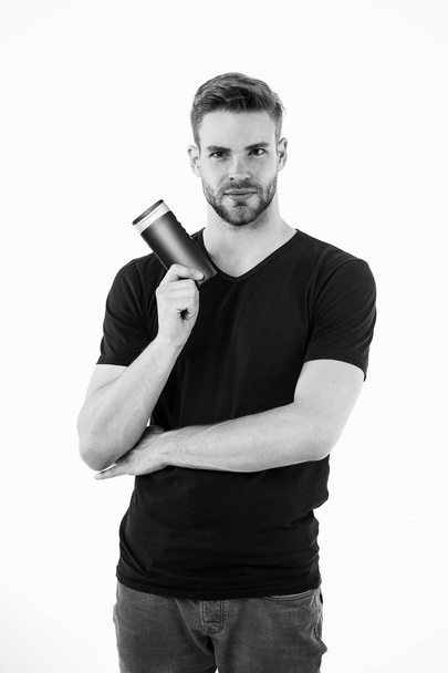 Man bearded stylish hold plastic shampoo bottle. Guy handsome use popular cosmetic or hygienic shampoo product. Man show his favorite shampoo conditioner for hair. Guy satisfied with this shampoo - Fotó, kép