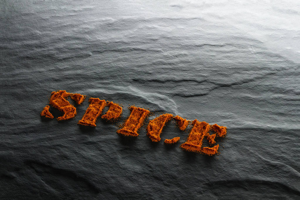 Spice. Ground paprika close up on black textural background - Photo, Image