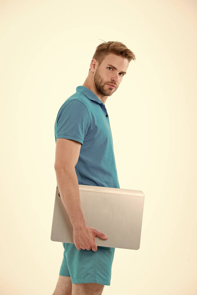 Man with laptop in blue sport clothes. Sportsman with computer for internet game. Sport bets and gambling online. New technology for modern life. Fashion for sport and fitness activity - Foto, Bild