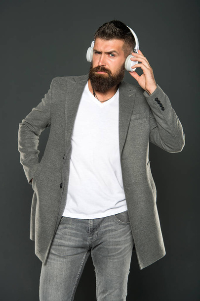 brutal caucasian hipster with moustache. Man in headphones. Audio book education. Mp3. modern life technology. Mature hipster with beard. Bearded man listen to music. Confident and handsome - 写真・画像