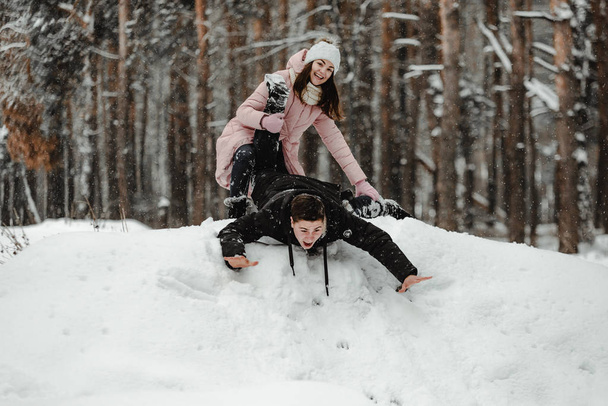 Happy friends in winterwear playing with snow in park. Ukraine 2019 - Valokuva, kuva