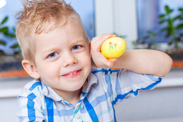 Little blonde boy is preparing for Easter and painting eggs. Colorful markers. Easter and holidays concept. - Fotoğraf, Görsel