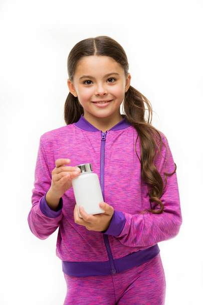 Vitamin supplements concept. Girl long hair hold plastic bottle with medicines copy space. Add vitamin to your ration. Need vitamin supplements. Most important vitamins and minerals every kid need - Photo, image