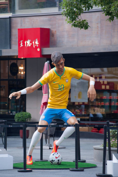 Μια γιγάντια μορφή από σούπερ σταρ του βραζιλιάνικου ποδοσφαίρου Neymar είναι στην επίδειξη στο Xintiandi, ένα τουριστικό αξιοθέατο συγκρότημα στο κέντρο της πόλης, Σαγκάη, Κίνα, 23 Ιουνίου 2014. - Φωτογραφία, εικόνα