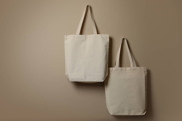 Eco tote bags hanging on color wall. Space for design - Photo, Image
