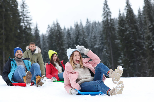 Group of excited friends with backpacks enjoying mountain view during winter vacation - Photo, Image