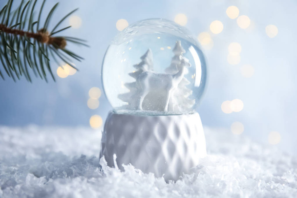 Glass globe with deer and trees on artificial snow - Foto, Imagen