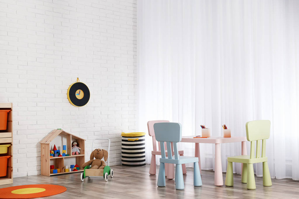 Modern child room interior with table and chairs - Φωτογραφία, εικόνα