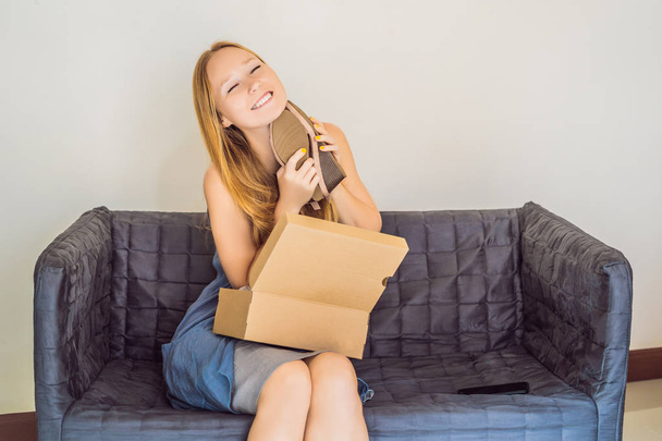 young woman received online shopping parcel opening boxes and buying fashion items by using credit card - Valokuva, kuva