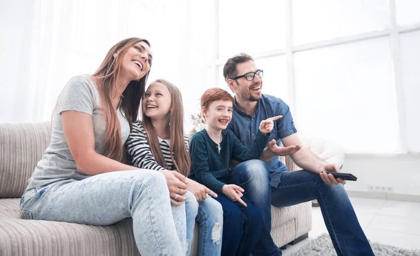 happy family watching their favorite TV show. - Фото, зображення