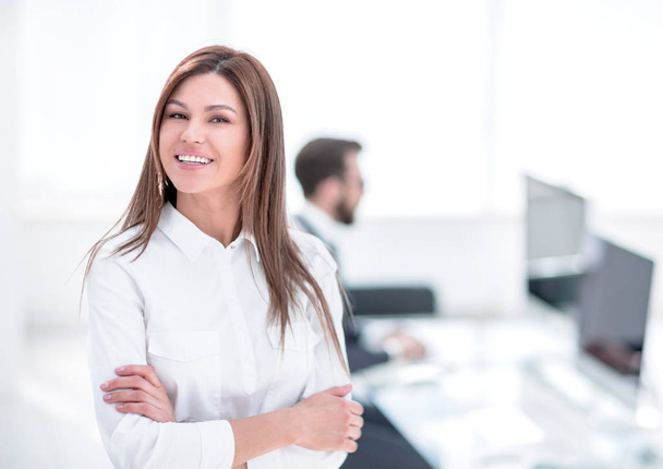 smiling business woman on the background of the workplace. - Foto, Bild