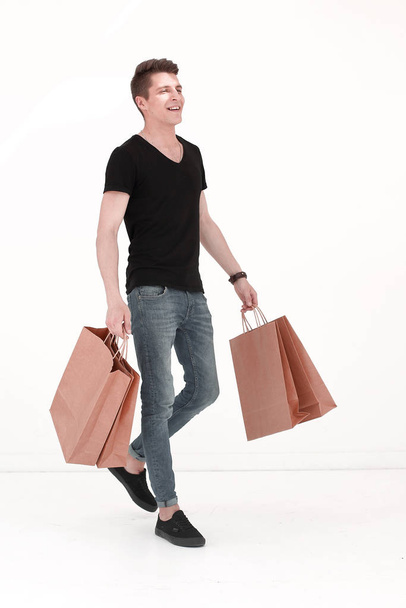 Handsome man in a black T-shirt with a bag - Photo, image