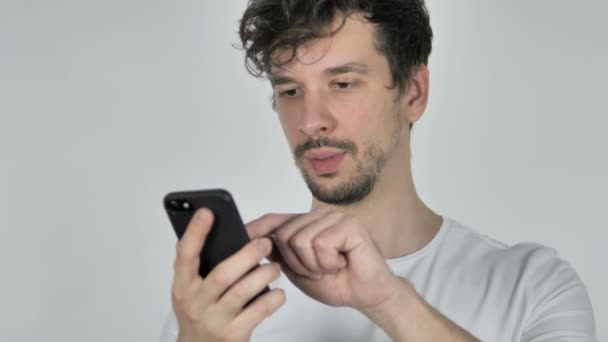 Young Casual Man Excited for Success while Using Smartphone - Video, Çekim