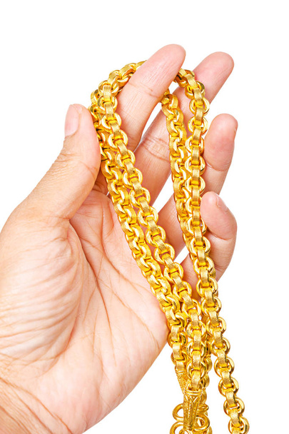 gold necklace on hand isolated on white background, Save clipping path. - Foto, imagen