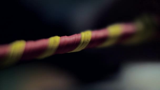 close view bright red and yellow plasticine stripe crumpled by mature man hand in blurred background - Filmagem, Vídeo