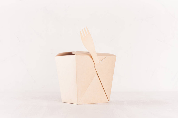 Blank brown paper noodles box and wooden fork for food takeaway on soft light white background, mockup for brand, design, advertising. - Zdjęcie, obraz