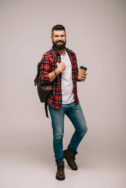 happy bearded man in checkered shirt holding coffee to go isolated on grey - Foto, Imagem