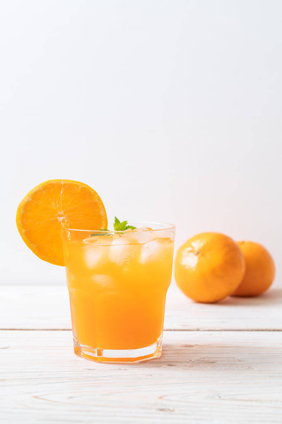 glass of orange juice with ice - 写真・画像