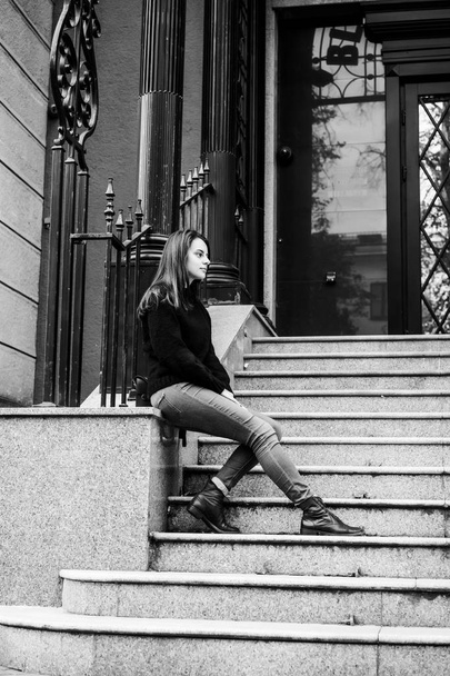 girl brunette runs down the stairs in the city and smiles - Foto, immagini