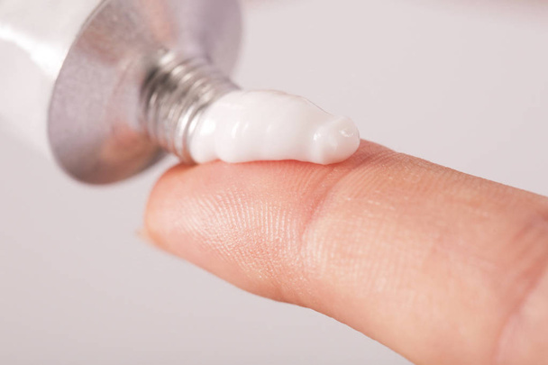 Close up image of hands with cream tube - Foto, afbeelding