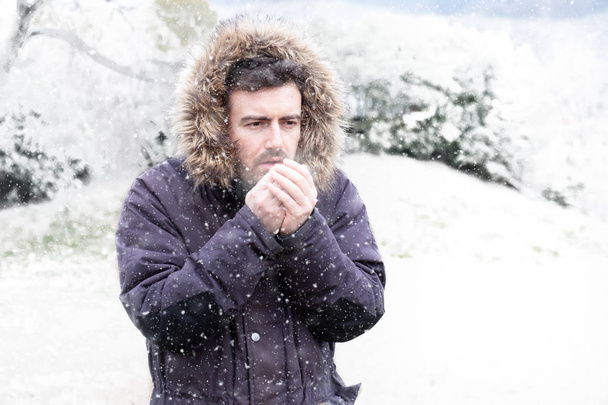 Man in cold and snowy weather storm in winter - Photo, Image