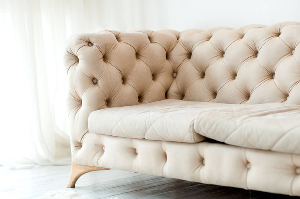 fragment of a beige sofa with buttons  - Foto, Imagem