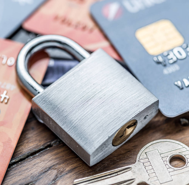 Credit cards and simle mechanical lock. Security concept. - Fotó, kép
