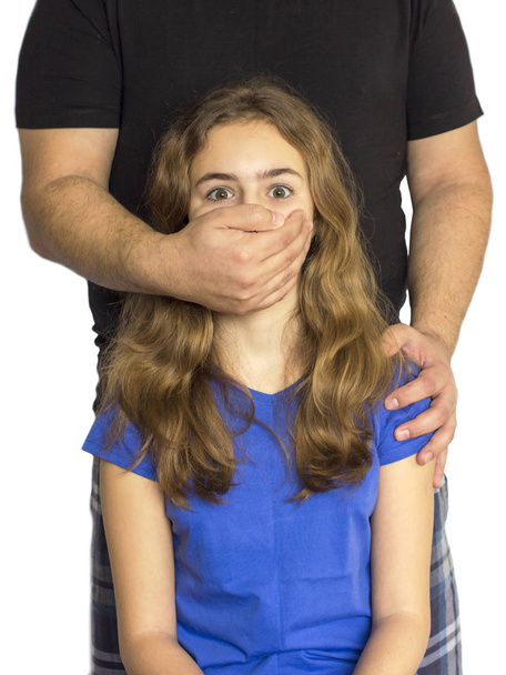 Child abuse, violence in family. Man shuts girl mouth with his hand - Photo, Image