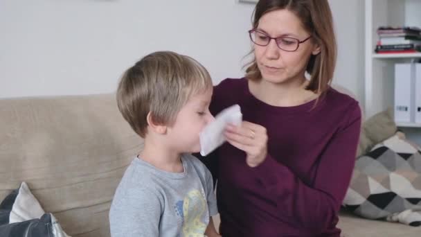 Mother and little boy with running nose, mom taking care of her sick toddler boy. - Πλάνα, βίντεο