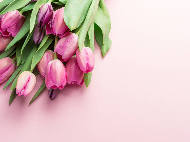 Bouquet pink tulips on lightpink background. Top view. - Fotó, kép