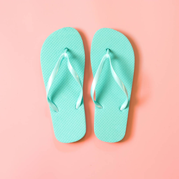 Summer concept. Green flip flops over pink background. View from above. Close up. - Photo, Image
