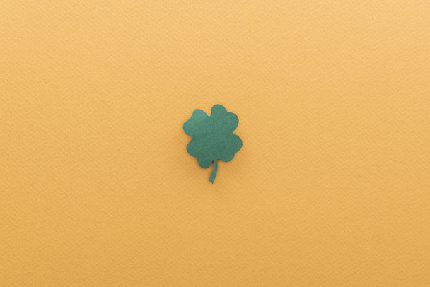 top view of shamrock isolated on orange with copy space, st patrick day concept - Fotoğraf, Görsel
