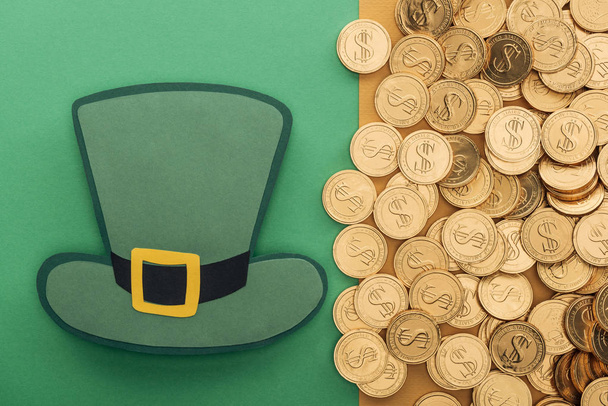 top view of golden coins with dollar signs and paper hat on green and orange background, st patrick day concept - Valokuva, kuva