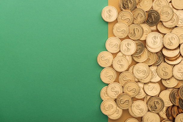 top view of golden coins with dollar signs and copy space on green and orange background, st patrick day concept - Photo, Image