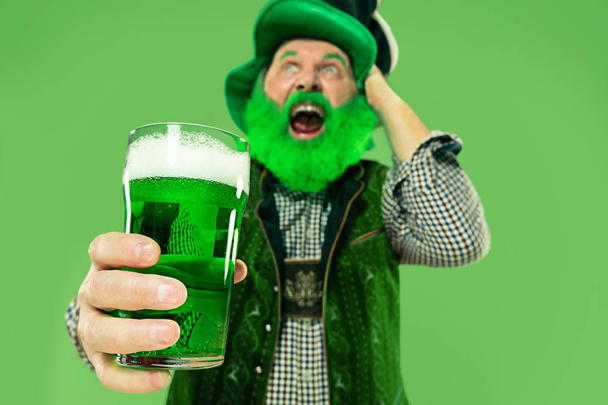 A man in a leprechaun hat at studio. He celebrates St. Patricks Day. - Photo, Image