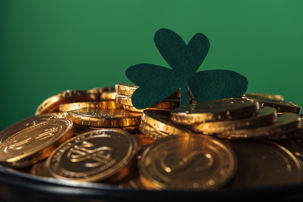shiny golden coins with shamrock isolated on green, st patrick day concept - Фото, изображение