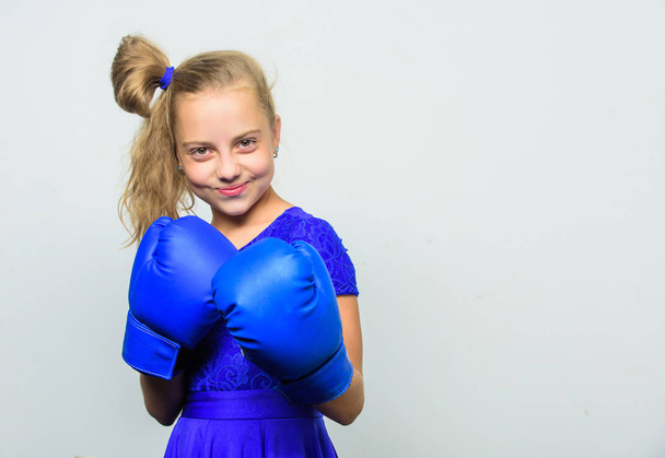 little girl in boxing gloves punching. knockout and energy. Sport success. training with coach. Fight. Boxer child workout, healthy fitness. Sport and sportswear fashion, copy space. Ready to fight - Foto, afbeelding