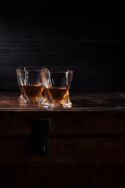 two glasses of whiskey on vintage wooden table   - Fotoğraf, Görsel