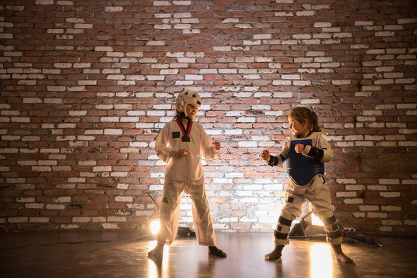 Two little girls training their karate skills. Standing in the position - Foto, Bild