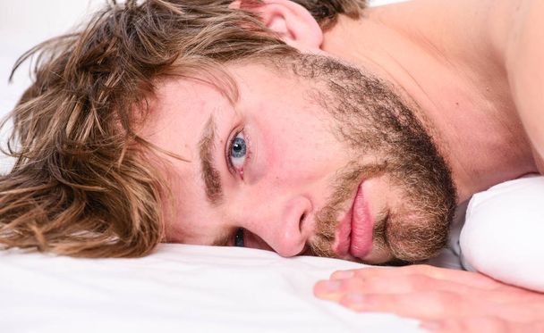 Man attractive macho relax and feel comfortable. Man unshaven bearded face sleep relax or just wake up. Simple tips to improve your sleep. Guy bearded macho relax in morning. Total relax concept - Foto, afbeelding