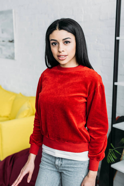 attractive african american girl in red sweatshirt looking at camera - Photo, Image