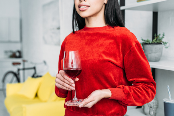 partial view of african american woman holding glass of wine - Foto, imagen