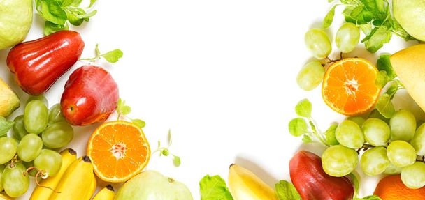 flat lay top view tropical fruits frame background: grape, rose apple, orange, spinach, mango, pear, guava and banana. Healthy drink ingredients. Vegetarian, vegan food concept. Detox - Foto, immagini