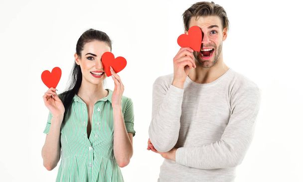 Man and woman couple in love hold red heart valentines cards on white background. Romantic couple in love. Romantic feelings concept. Valentines day and love. Handsome man and pretty girl in love - Photo, image
