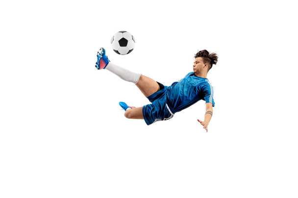 Young boy with soccer ball doing flying kick - Foto, afbeelding