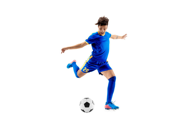 Young boy with soccer ball doing flying kick - Φωτογραφία, εικόνα