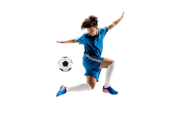 Young boy with soccer ball doing flying kick - Фото, изображение