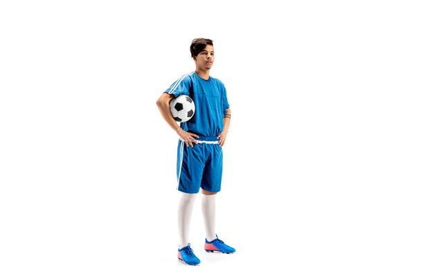 Young fit boy with soccer ball standing isolated on white - Fotoğraf, Görsel