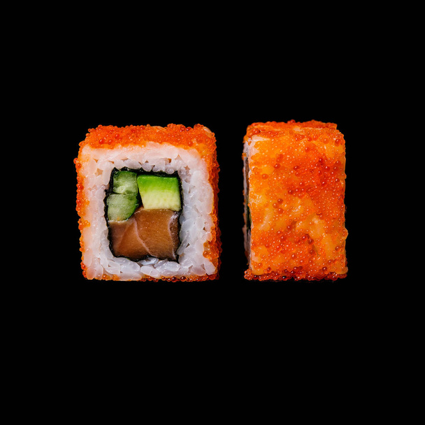 Sushi. California roll with salmon, avocado, cucumber and tobiko, isolated in black background - Photo, Image