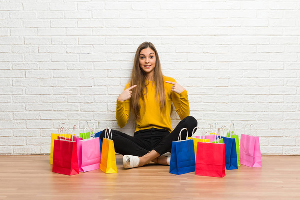 Young girl with lot of shopping bags with surprise facial expression - Photo, Image